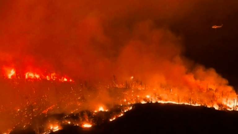 In California, violent fires force thousands of residents to flee