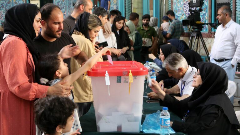 Iranians vote in second round of presidential election pitting reformist against ultraconservative