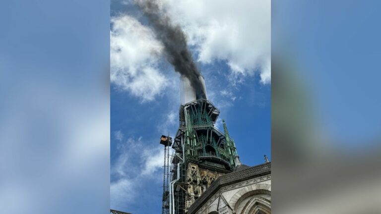 The spire of Rouen’s Notre-Dame Cathedral on fire