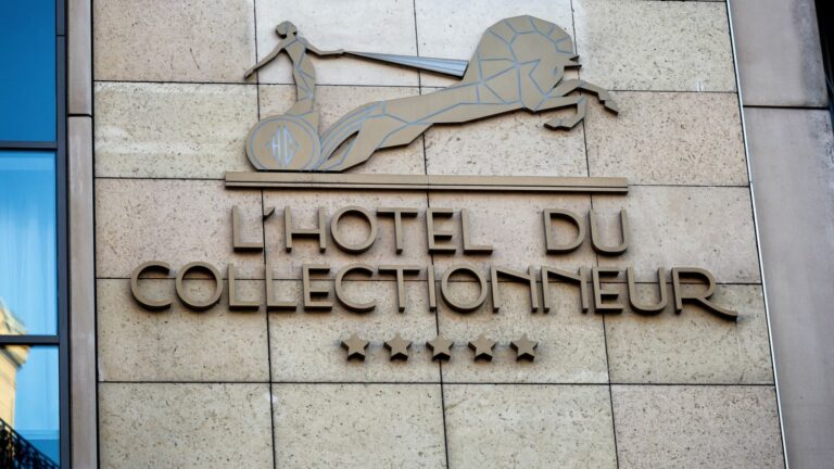 Workers walk out at the Hotel du Collectionneur, privatized by the International Olympic Committee