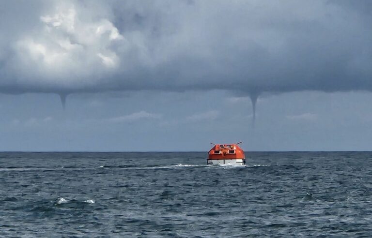 About ten waterspouts brush past the Magdalen Islands