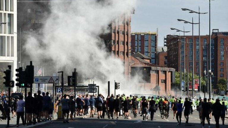 Clashes between police and far-right protesters break out in several cities in the UK