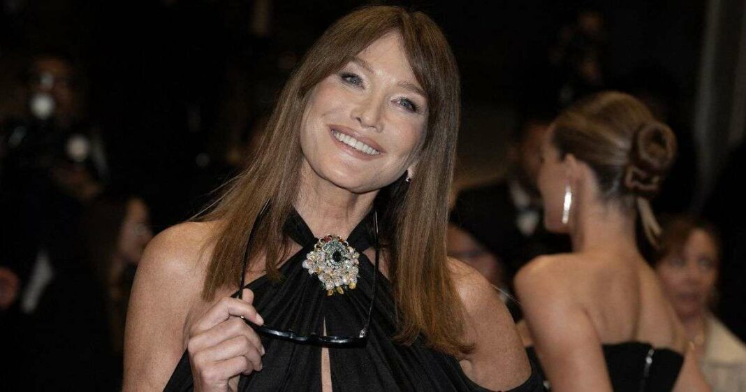 Carla Bruni captivates at 56 in a plunging neckline gown, embracing this season's trending hue.