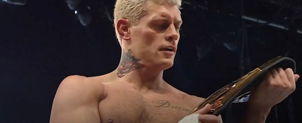 Cody Rhodes looking at his championship title