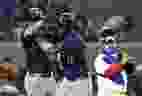 Mitch Haniger des Mariners de Seattle célèbre son home run de deux points avec Julio Rodriguez, à gauche, sous le regard du receveur des Blue Jays Alejandro Kirk lors du huitième à Toronto, le mardi 9 avril 2024. 