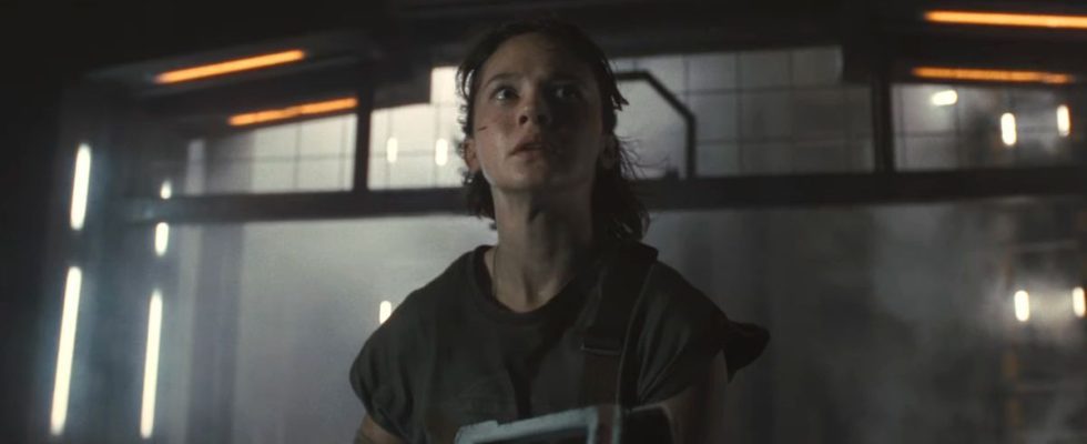 Cailee Spaeny looks terrified while holding a pulse rifle in an empty hallway in Alien: Romulus.