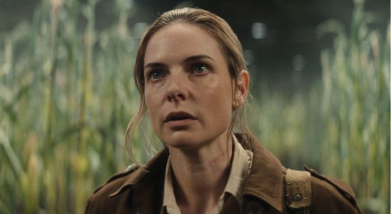 Rebecca Ferguson stands shocked in a corn field in Silo.