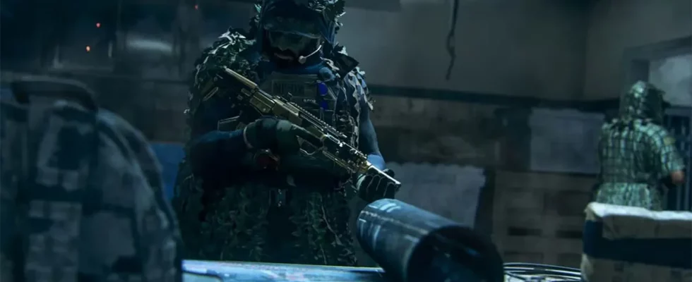 A CoD player holding an assault rifle while looking at a blueprint on a table.
