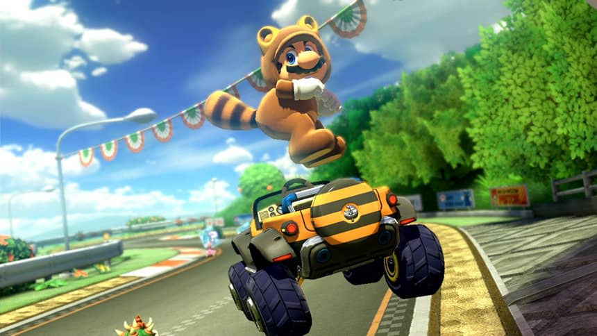 Mario dans son costume Tanooki (ressemblant à un raton-laveur), sautant en l'air et sortant ses fesses au-dessus de son tout-terrain rayé.