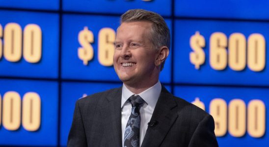 Ken Jennings smiling in front of game board on Celebrity Jeopardy!