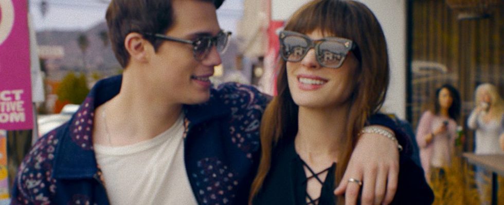 Nicholas Galitzine and Anne Hathaway walk down the street together in The Idea Of You.