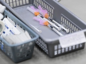 Un panier d'aiguilles contenant des vaccins contre la COVID-19 attend d'être administré aux patients dans une clinique COVID-19 à Ottawa le 30 mars 2021.