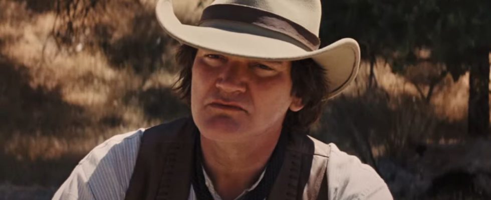 Quentin Tarantino listening intently while dressed in western gear in Django Unchained.