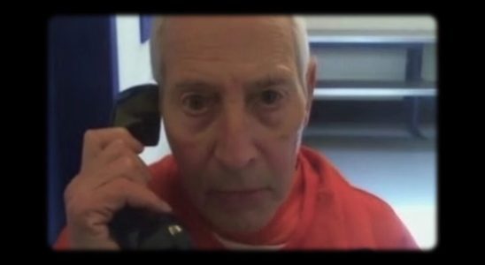 Robert Durst talks on a phone in prison in