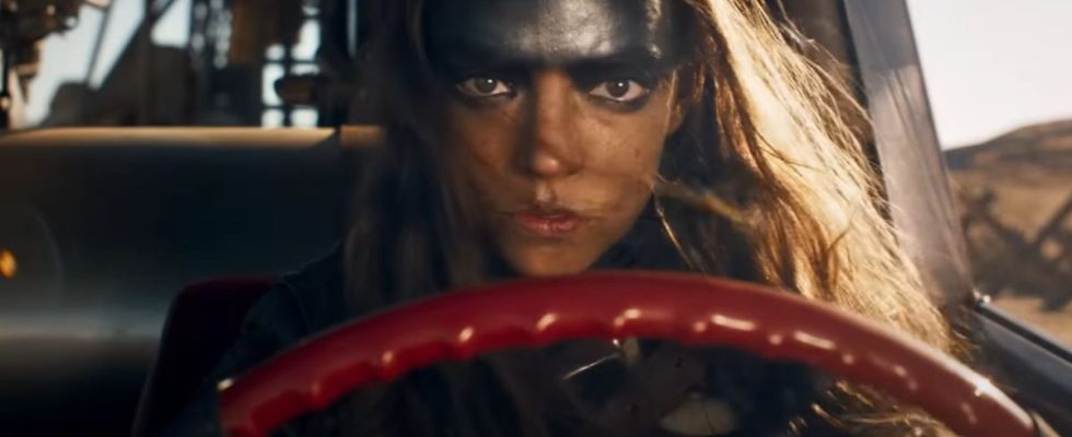 Anya Taylor-Joy as Furiosa driving a car looking determined in Furiosa.