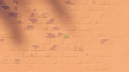 Réticule Hiko Valorant : Une croix verte sur un mur dans Valorant.