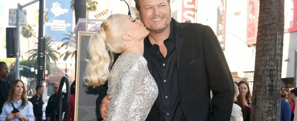 Gwen Stefani kissing Blake Shelton on the cheek at her Hollywood Walk of Fame Ceremony.