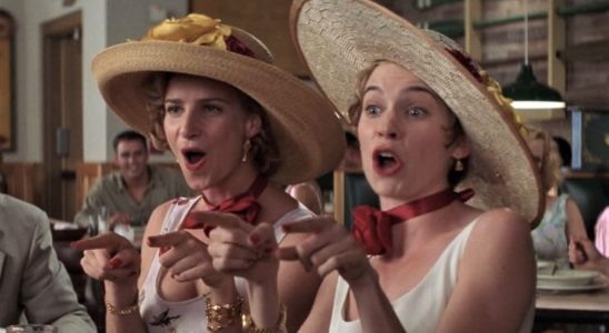 Rachel Griffiths and Carrie Preston wear large hats as they sing "I Say a Little Prayer" in My Best Friend