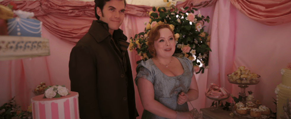 Colin Bridgerton and Penelope Featherington standing in a sweet shop in Season 3, Episode 3