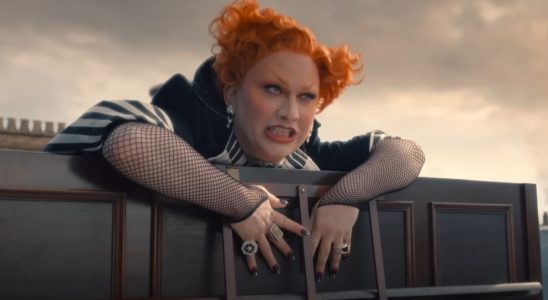 Jinkx Monsoon looking over a rooftop ledge