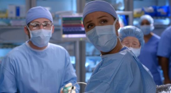 Camilla Luddington looks up while wearing scrubs in the operating room on Grey