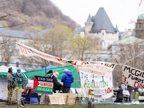 Des militants pro-palestiniens sont vus dans leur campement installé sur le campus de l'Université McGill à Montréal, le lundi 29 avril 2024. L'université affirme qu'elle fera des efforts pour désamorcer la situation avant de demander l'aide de la police pour un camp installé sur le campus. par des militants pro-palestiniens.