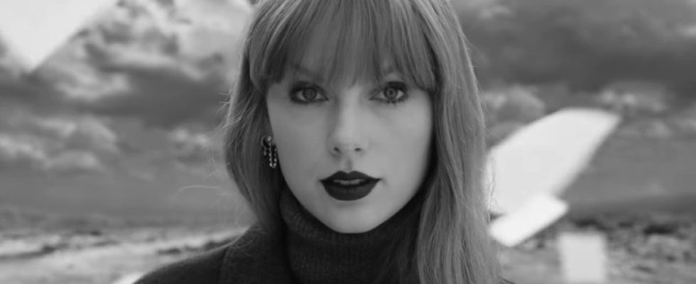Black and white screenshot of Taylor Swift looking into camera in Fortnight video.