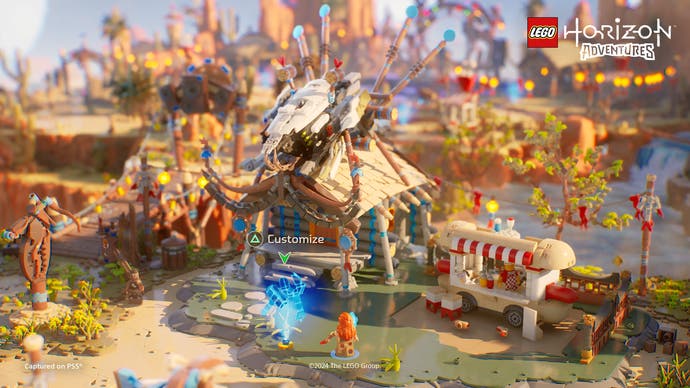 Capture d'écran de Lego Horizon Adventures montrant une construction Lego à construire au milieu d'un petit village.