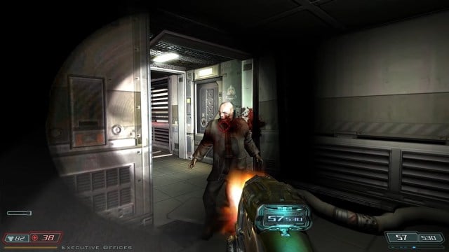 Doom 3 : le joueur tire sur un zombie qui a émergé par une porte.