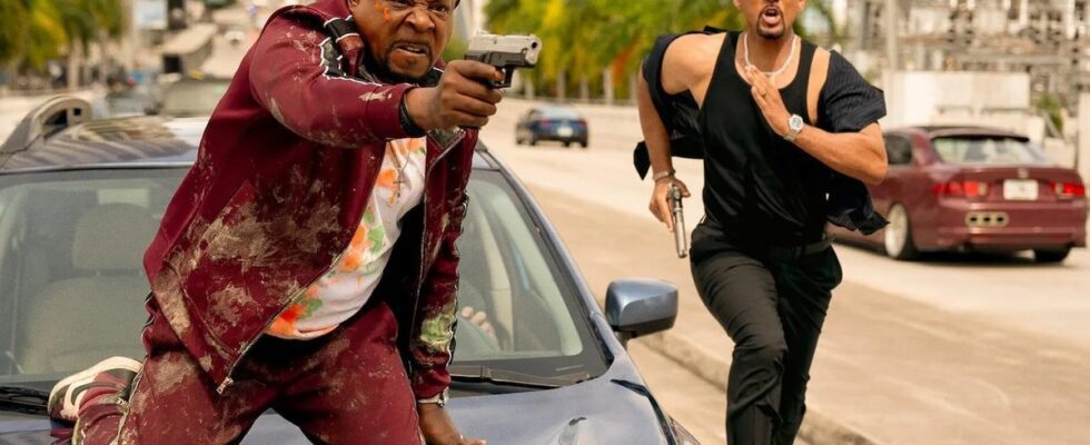 Martin Lawrence with gun on car and Will Smith running in Bad Boys: Ride or Die still