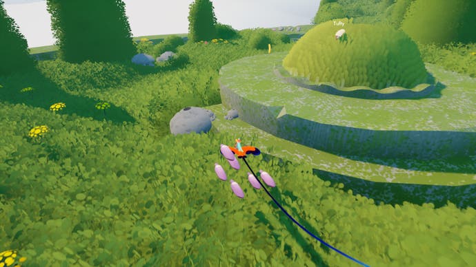 Le joueur s'approche d'une colline de moutons arrondie dans Flock.