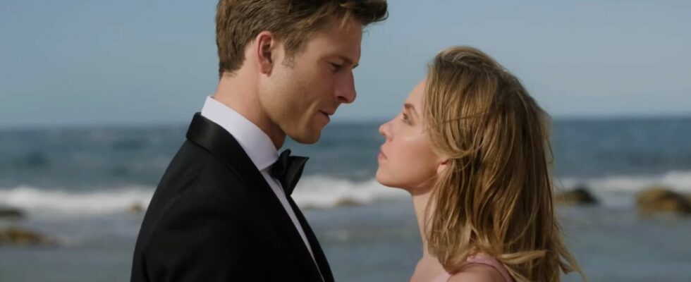 Glen Powell and Sydney Sweeney stare each other down in front of the ocean in Anyone But You.