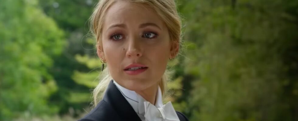 Blake Lively in A Simple Favor wearing a tux and looking over her shoulder.