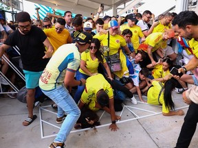 Les supporters de la Colombie et de l'Argentine tentent de franchir la porte au milieu des perturbations du match final de la CONMEBOL Copa America 2024 entre l'Argentine et la Colombie au Hard Rock Stadium le 14 juillet 2024 à Miami Gardens, en Floride.