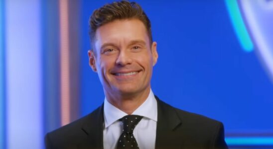 Ryan Seacrest smiles in an ad for the upcoming 2024 season of Wheel of Fortune.