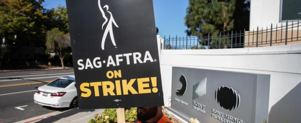 LOS ANGELES, CALIFORNIA - OCTOBER 11: A worker holding a picket sign stands in front of the Sony Pictures Studio during a SAG-AFTRA picket line on October 11, 2023 in Culver City, California. The WGA (Writers Guild of America) has reached a deal with Hollywood studios after 146 days on strike, ending their strike at midnight on September 27. SAG-AFTRA has not reached a deal with the studios and has been on strike since July 14.