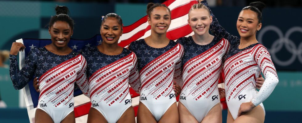 Simone Biles, Jordan Chiles, Hezly Rivera, Jade Carey and Sunisa Lee of the U.S. women's gymnastics team celebrate winning gold at the 2024 Olympics.