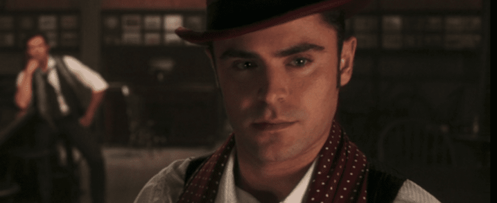 Zac Efron in maroon top hat in The Greatest Showman
