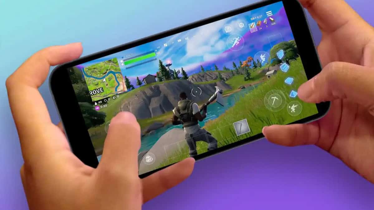 Fortnite image of hands holding a phone, playing fortnite