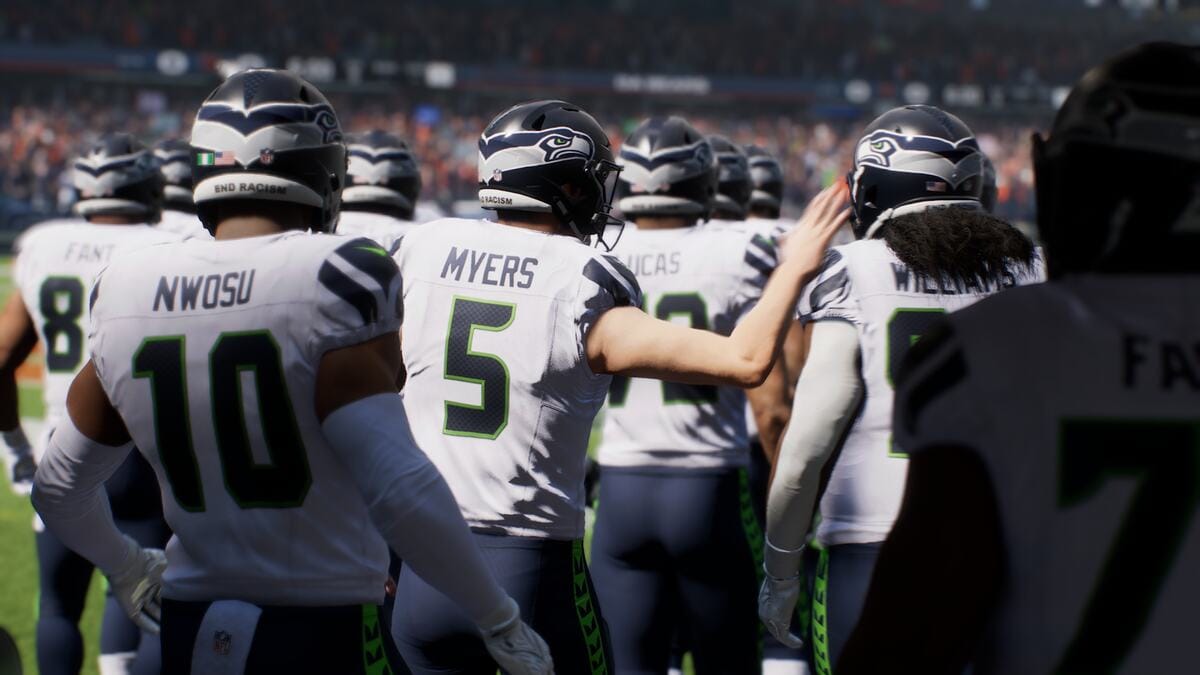 Madden 25 review: A football team wearing white jerseys walks out onto the field.