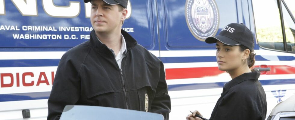 Timothy McGee and Ziva David standing near NCIS van