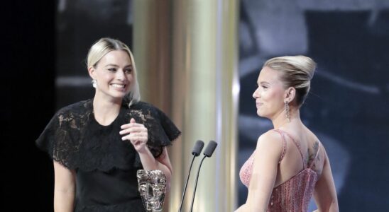 Margot Robbie presenting Scarlett Johansson an award at the 73rd British Academy Film Awards