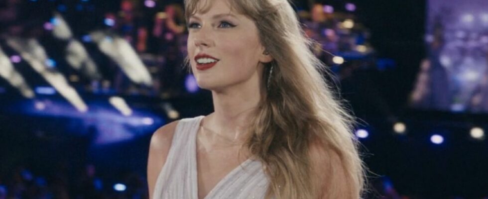 Taylor Swift smiling toward the crowd during the Eras Tour.