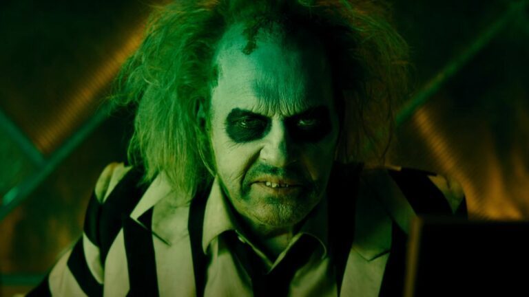 Michael Keaton grimaces in full makeup in Beetlejuice Beetlejuice.