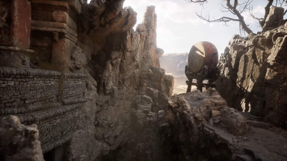 Black Myth Wukong éditions et précommande : Une vallée rocheuse avec un bâtiment en ruine à gauche et un grand tambour sur une tour en bois à droite.