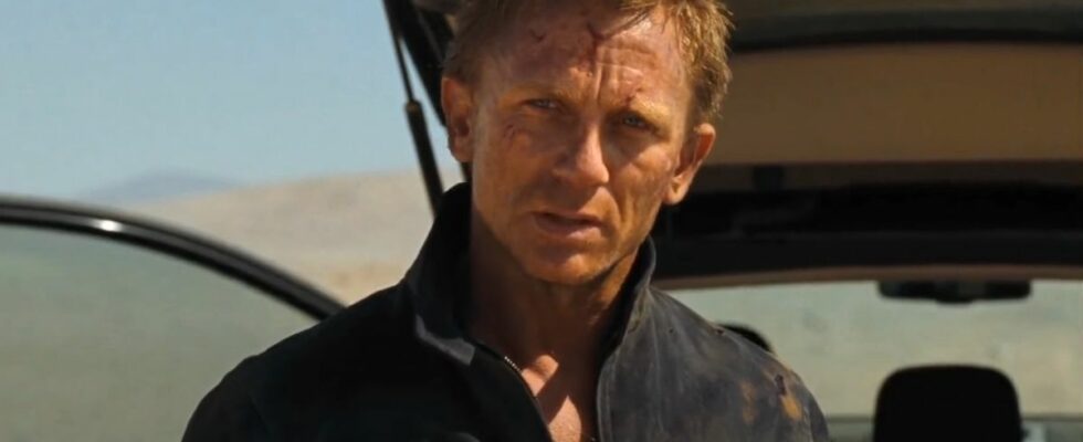 Daniel Craig stands with a determined expression, in front of his car trunk, in Quantum of Solace.