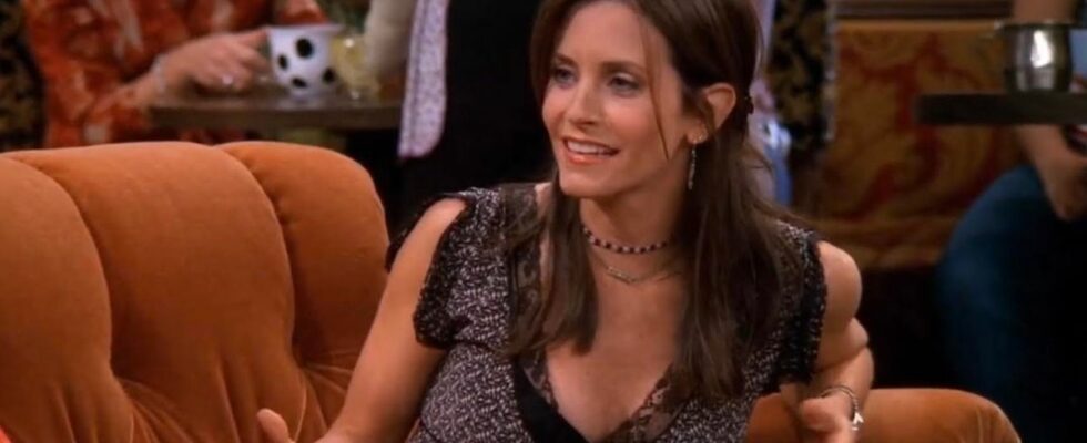 courteney cox as monica geller sitting on the orange couch in central perk in friends.