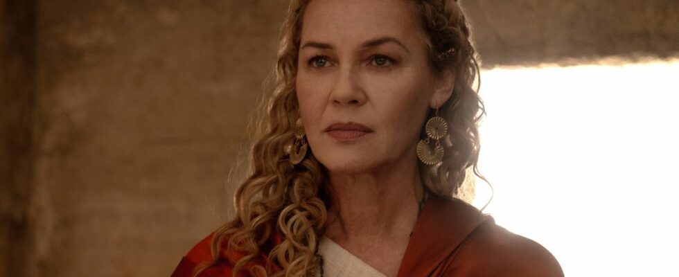 Connie Nielsen stands in a room looking regal with a red cloak in Gladiator II.