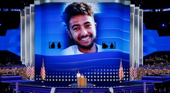 An image of Hersh Goldberg-Polin is displayed as his parents Jon Polin and Rachel Goldberg speak on stage during the third day of the 2024 DNC.