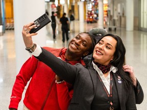 L'athlète Jesse Zesseu prend un selfie avec l'hôtesse de l'air Veronica Gutierrez Cardenas après son retour des Jeux paralympiques de Paris 2024, à l'aéroport Pearson de Toronto à Mississauga, en Ontario, le lundi 9 septembre 2024.